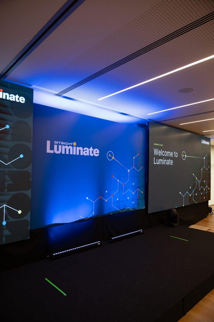 Bitsight Luminate conference stage with digital screens and branding elements.