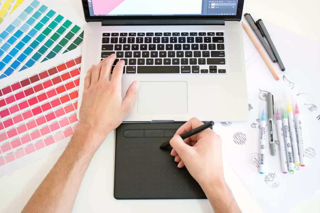 Modern graphic design workspace with color swatches and digital tools.