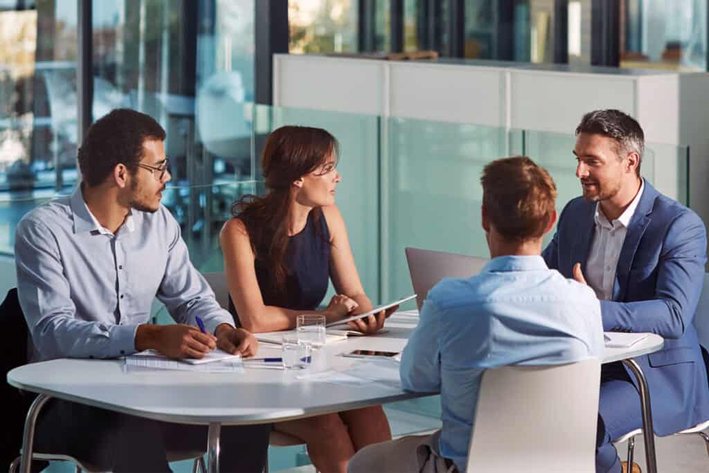 Team of communication leaders in a business meeting discussing strategies.